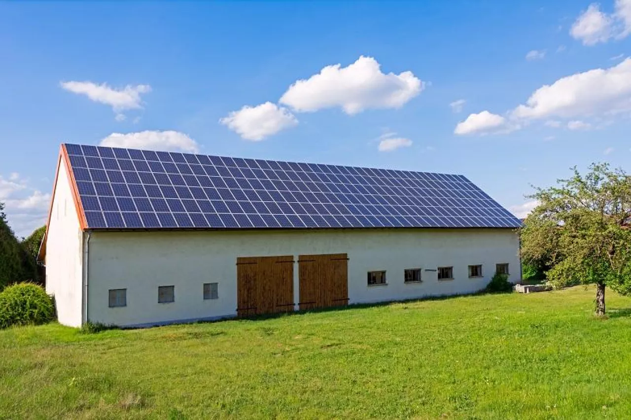 Green energy with solar collectors on the roof of an agricultural building