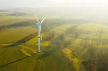 Wind turbines or wind mills farm in the field at sunlight