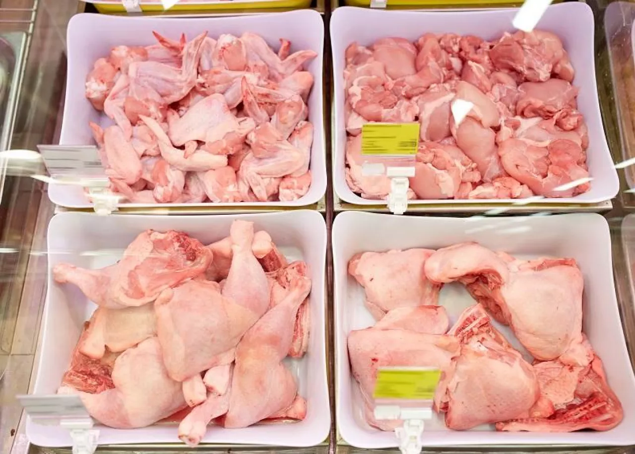sale and food concept - poultry meat in bowls at grocery stall