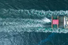 stern of Cargo container Ship in the ocean sea concept logistic transportation export to customs forwarding logistics service. Container on Bulk ship