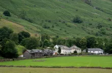 White cottage houses at the edge of the cliff in the farmlands at the Lake District area in United Kingdom