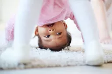 Active little girl somersaulting