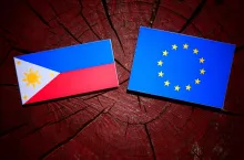 Philippines flag with EU flag on a tree stump isolated