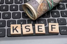 KSEF inscription on the computer keyboard, national e-invoice system, the inscription lies on the laptop next to Polish money